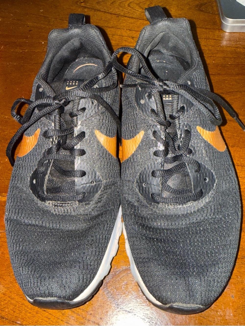 Nike Black Knit Sneakers with Gold Swoosh Accents